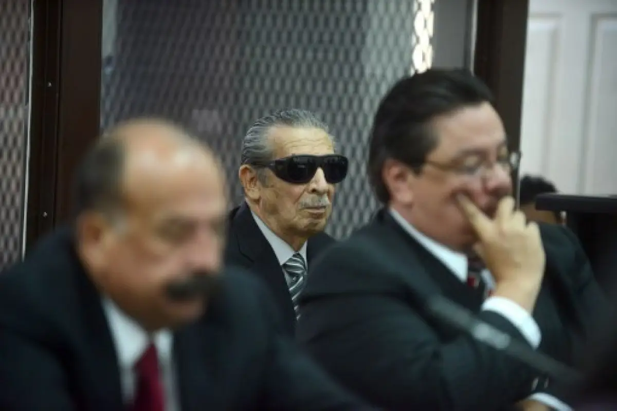 Former Guatemalan de facto president (1982-1983), retired General Jose Efrain Rios Montt, 86, (C) is seen wearing dark glasses prescribed after his cataract surgery, during a court hearing in Guatemala City on November 19, 2013. A tribunal confirmed that 