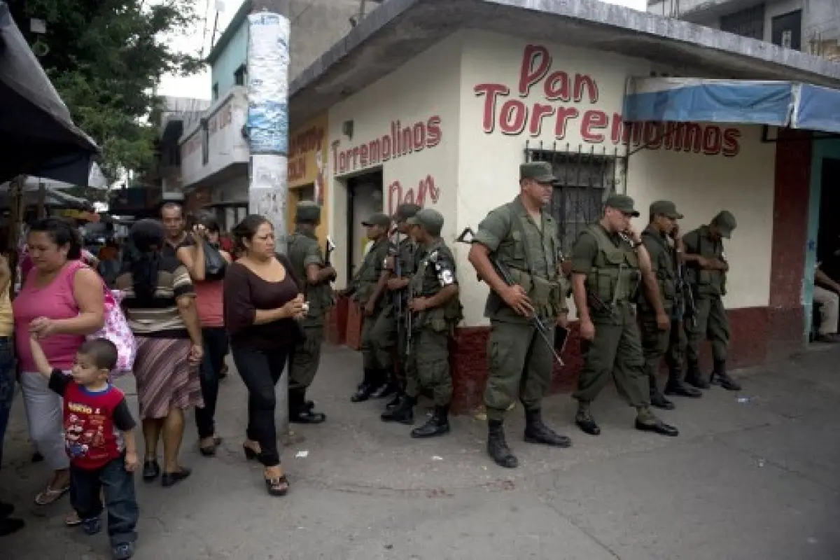 Soldiers patrol on May 11, 2012 along El Limon neighborhood, northern outskirts of Guatemala City, during an operation in the frame of the security plan of President Otto Perez Molina to reduce the incidence of violence in the country. AFP PHOTO Johan ORD