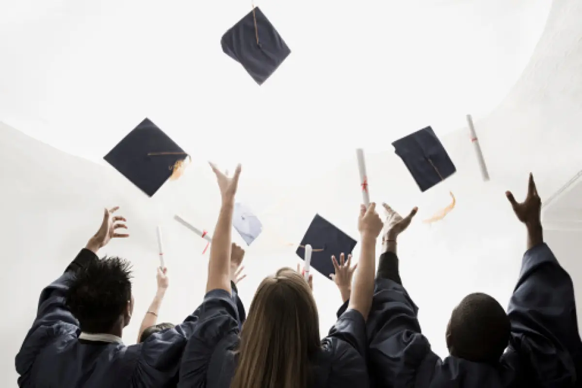 Graduates throwing mortarboards