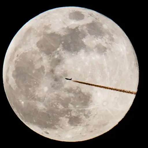 A plane flies past the full moon in Nuremberg, on February 19, 2019. (Photo by Daniel Karmann / dpa / AFP) / Germany OUT