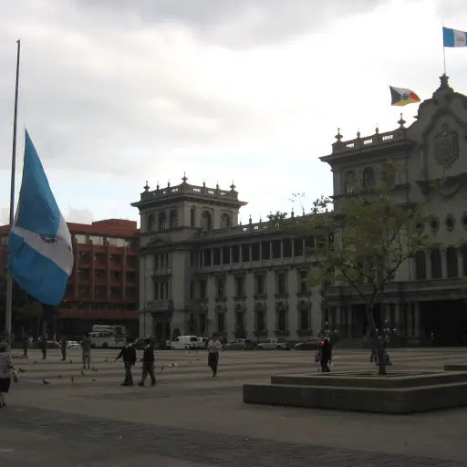Soldiers taking down the flag before the daily hour of raining, outside the National Palace.