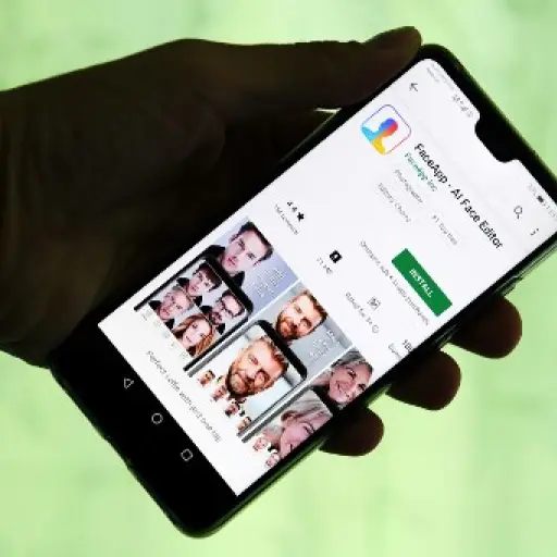 This illustration picture shows FaceApp application displayed on the screen of a smartphone. - The chart-topping Russian-made application FaceApp, which allows millions of users to see how they will look as they age, finds itself in the eye of a political
