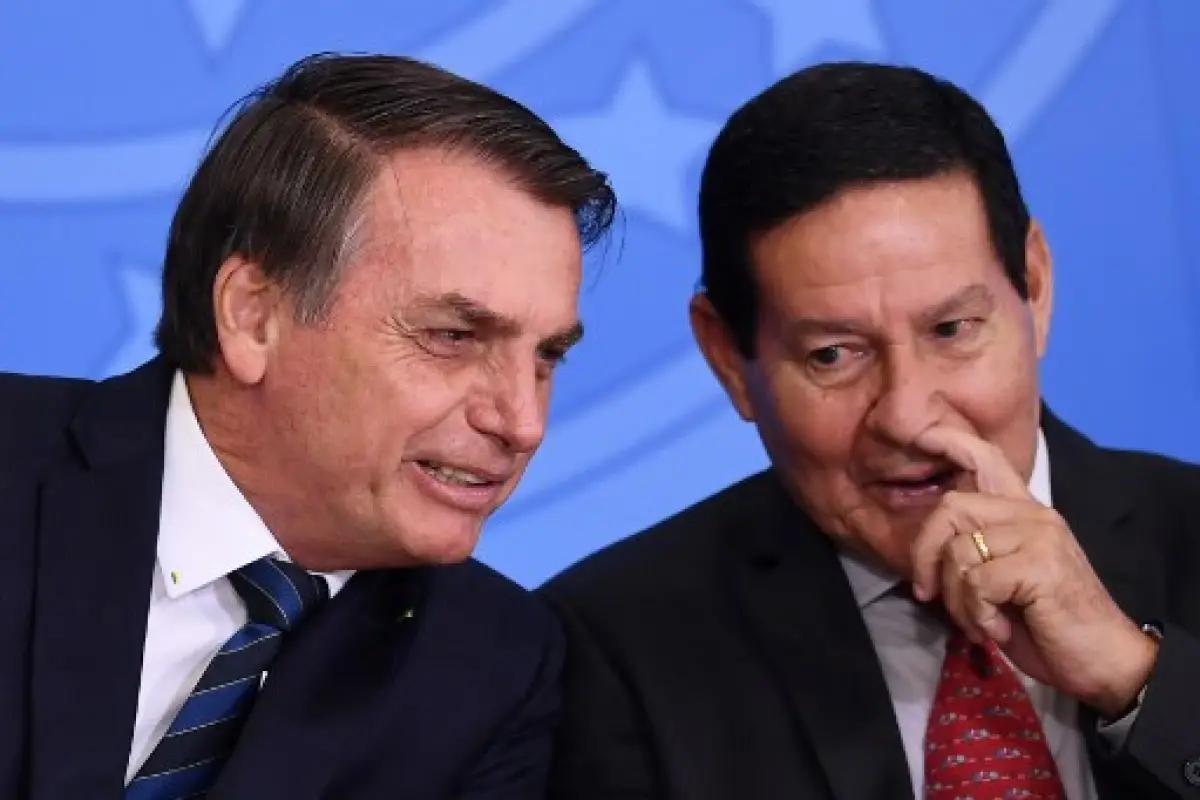 Brazilian President Jair Bolsonaro (L) and Vice-President Hamilton Mourao speak during the inauguration ceremony of Luiz Eduardo Ramos as Head of the Secretariat of Government of the Presidency at Planalto Palace in Brasilia, on July 04, 2019. - Ramos rep