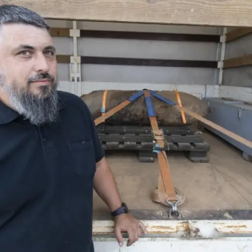Rene Bennert from the bomb disposal team poses next to a defused WWII bomb fixed on a truck on July 7, 2019 in Frankfurt am Main, western Germany. - Thousands of residents in German city Frankfurt were free to return to their homes, as authorities reporte