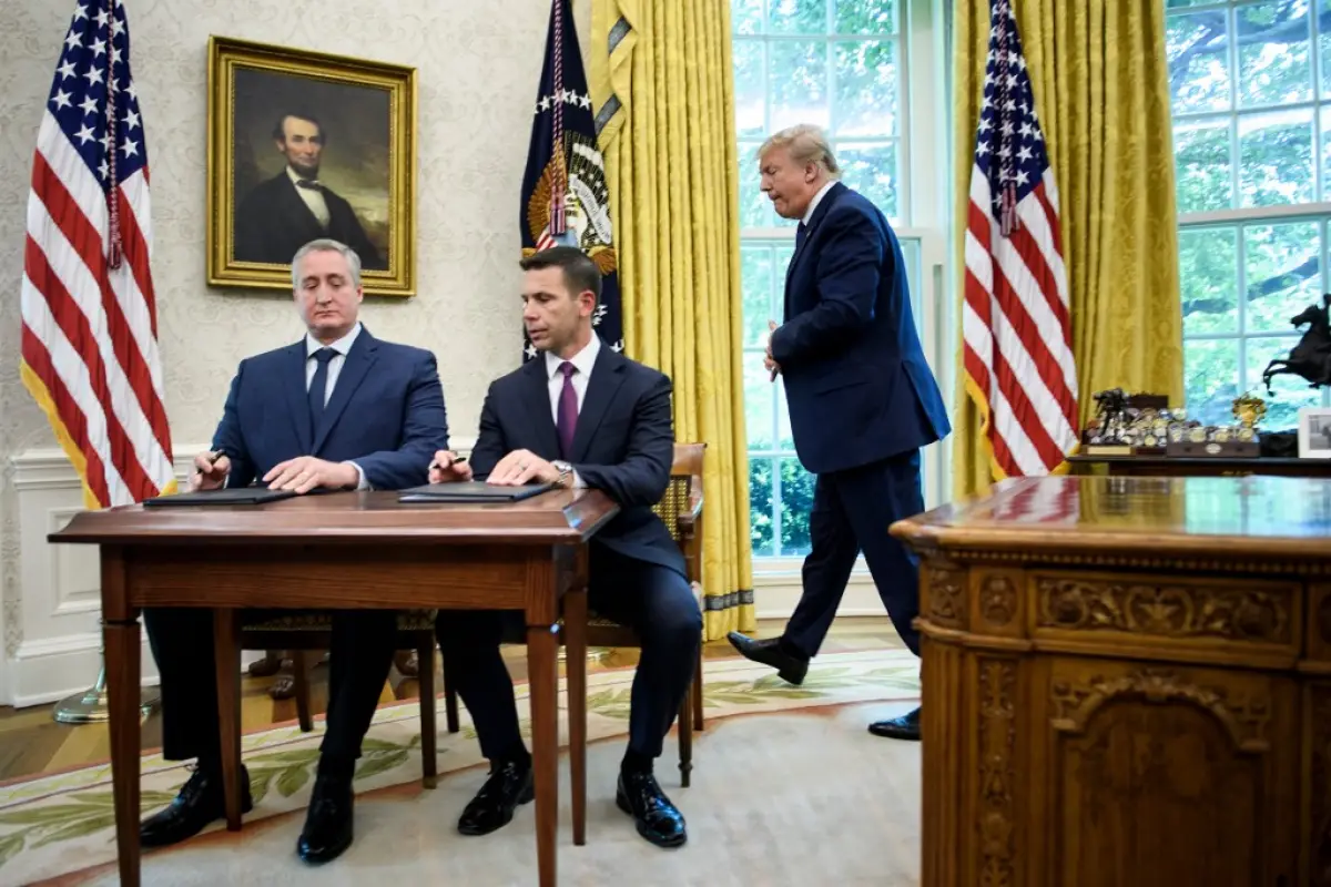 US President Donald Trump (R) walks to watch as Guatemala's Interior Minister Enrique Degenhart (L) and Acting US Secretary of Homeland Security Kevin K. McAleenan (C) sign a safe-third agreement, regarding people seeking asylum while passing through Guat