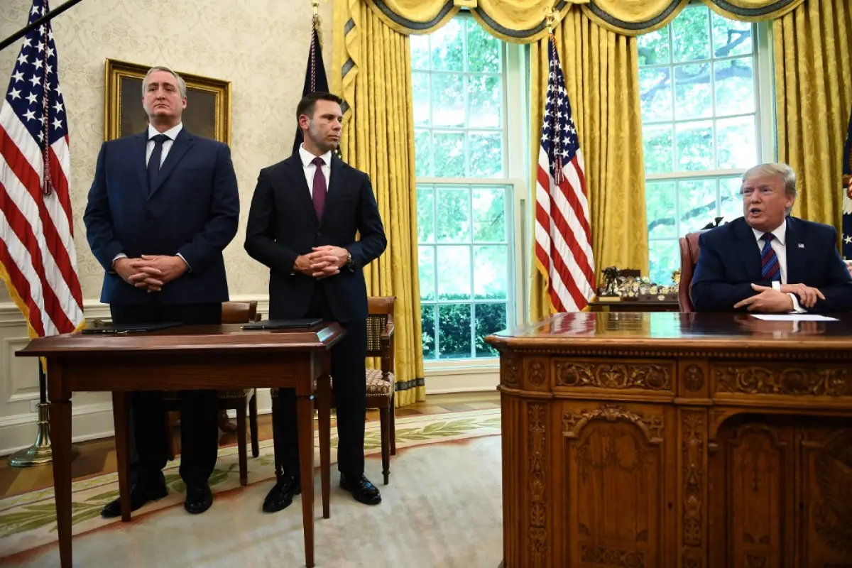 US President Donald Trump speaks to the media as Guatemalan minister of Interior and Home Affairs Enrique Degenhart (L) and Acting US Department of Homeland Security Secretary Kevin McAleenan look on after signing an asylum agreement in the Oval Office of