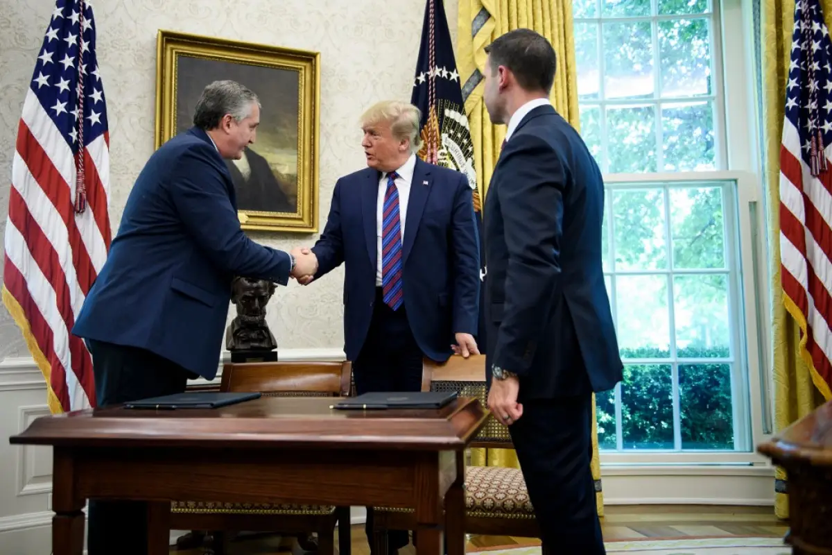 US President Donald Trump (C) shakes Guatemala's Interior Minister Enrique Degenhart (L) hand as acting US Secretary of Homeland Security Kevin K. McAleenan (R) watches after a safe-third agreement was signed, regarding people seeking asylum while passing