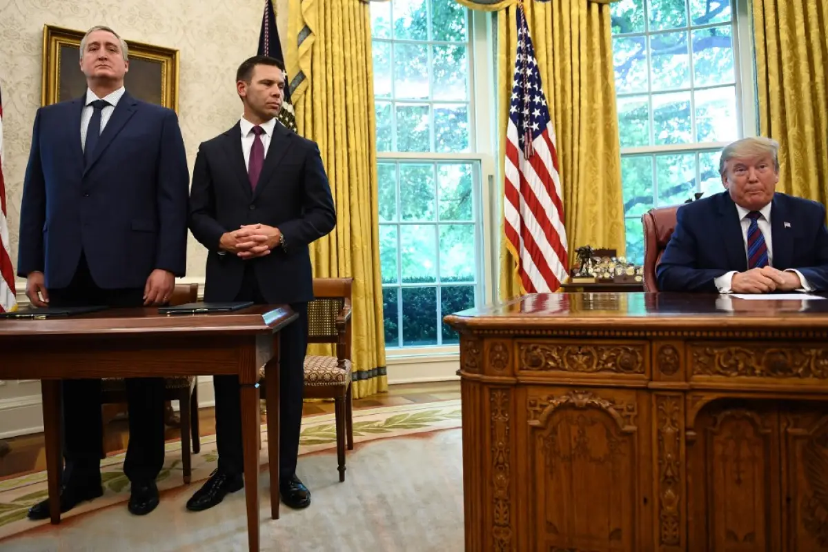 US President Donald Trump speaks to the media as Guatemalan minister of Interior and Home Affairs Enrique Degenhart (L) and Acting US Department of Homeland Security Secretary Kevin McAleenan look on after signing an asylum agreement in the Oval Office of