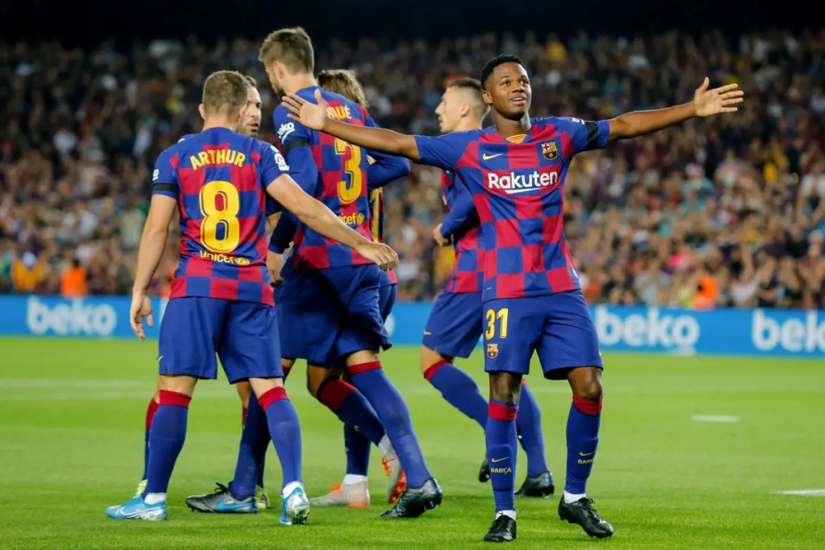 Barcelona´s Guinea-Bissau forward Ansu Fati (R) celebrates after scoring a goal during the Spanish league football match FC Barcelona against Valencia CF at the Camp Nou stadium in Barcelona on September 14, 2019. (Photo by PAU BARRENA / AFP)