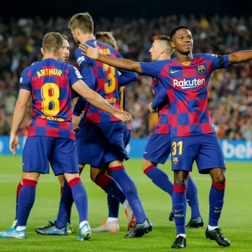 Barcelona´s Guinea-Bissau forward Ansu Fati (R) celebrates after scoring a goal during the Spanish league football match FC Barcelona against Valencia CF at the Camp Nou stadium in Barcelona on September 14, 2019. (Photo by PAU BARRENA / AFP)