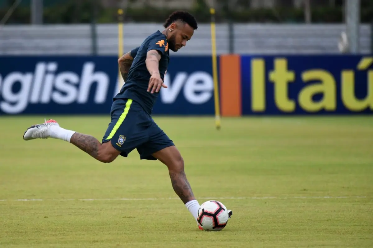 Brazil's Neymar kicks the ball during a team training session in Singapore on October 7, 2019, ahead of their friendly international football matches against Senegal and Nigeria. - Brazil's Neymar (C) and teammates attend a training session in Singapore o