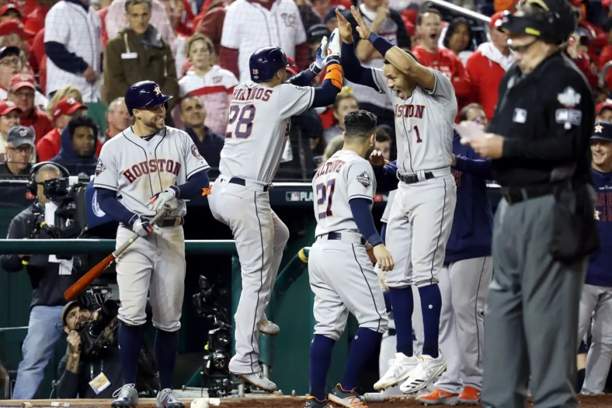 WASHINGTON, DC - OCTOBER 25: Robinson Chirinos #28 of the Houston Astros is congratulated by his teammate Carlos Correa #1 after hitting a solo home run against the Washington Nationals during the sixth inning in Game Three of the 2019 World Series at Nat