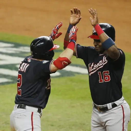HOUSTON, TEXAS - OCTOBER 23: Adam Eaton #2 of the Washington Nationals is congratulated by his teammate Victor Robles #16 after hitting a two-run home run against the Houston Astros during the eighth inning in Game Two of the 2019 World Series at Minute M