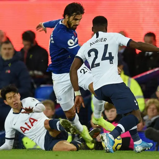 Everton's Portuguese midfielder André Gomes (C) is brought down in a challenge by Tottenham Hotspur's South Korean striker Son Heung-Min (L floor) as Tottenham Hotspur's Ivorian defender Serge Aurier (R) comes in to challenge for the ball leading to an in