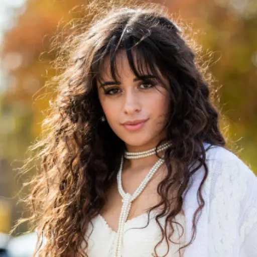 PARIS, FRANCE - SEPTEMBER 27: American singer Camila Cabello is seen wearing total look Izaak Azanei white pants, cardigan, necklace, cropped top during Paris Fashion Week Womenswear Spring Summer 2020 on September 27, 2019 in Paris, France. (Photo by Chr
