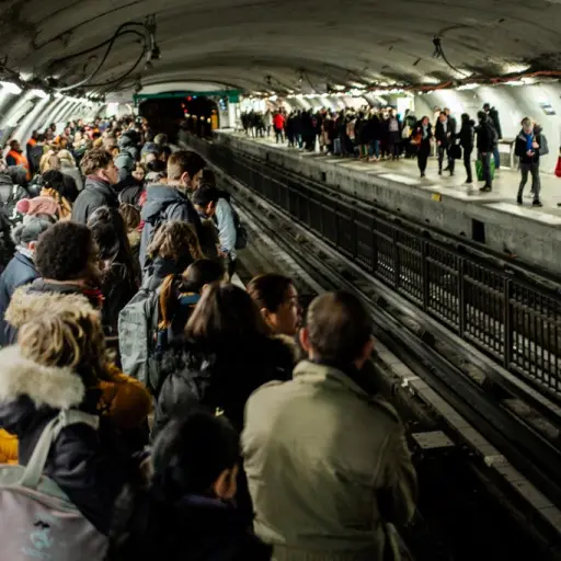 Commuters wait for a train in Chatelet subway station in Paris, on December 16, 2019, during a strike of Paris' public transports operator RATP and of the French state railway company SNCF employees over French government's plan to overhaul the country's 