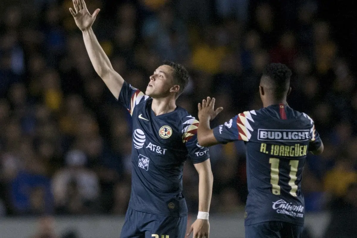 America's Federico Vinas (L) celebrates after scoring against Tigres during the second leg, quarterfinal Mexican Apertura 2019 tournament football match at the Universitario stadium in Monterrey, Mexico, on December 1, 2019. (Photo by Julio Cesar AGUILAR 