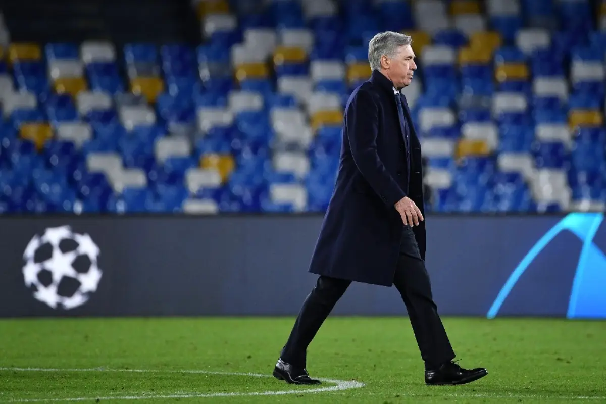 Napoli's Italian head coach Carlo Ancelotti goes to congratulate his players at the end of the UEFA Champions League Group E football match Napoli vs Genk on December 10, 2019 at the San Paolo stadium in Naples. (Photo by Tiziana FABI / AFP)