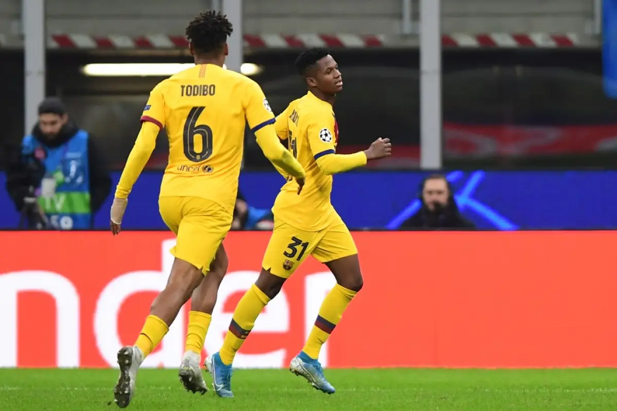 Barcelona´s Guinea-Bissau forward Ansu Fati (R) celebrates after scoring  during the UEFA Champions League Group F football match Inter Milan vs Barcelona on December 10, 2019 at the San Siro stadium in Milan. (Photo by Miguel MEDINA / AFP)