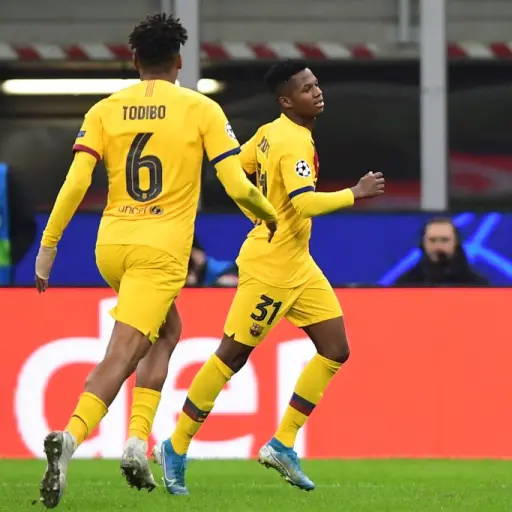 Barcelona´s Guinea-Bissau forward Ansu Fati (R) celebrates after scoring  during the UEFA Champions League Group F football match Inter Milan vs Barcelona on December 10, 2019 at the San Siro stadium in Milan. (Photo by Miguel MEDINA / AFP)