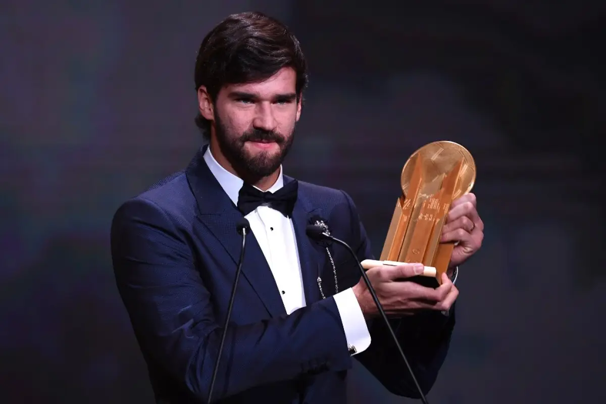 Liverpool's Brazilian goalkeeper Alisson Becker reacts after winning the Yachine trophy for best goalkeeper of the world during the Ballon d'Or France Football 2019 ceremony at the Chatelet Theatre in Paris on December 2, 2019. (Photo by FRANCK FIFE / AFP