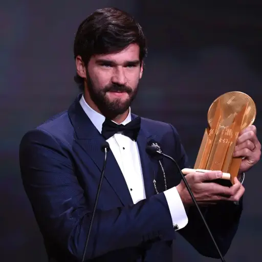 Liverpool's Brazilian goalkeeper Alisson Becker reacts after winning the Yachine trophy for best goalkeeper of the world during the Ballon d'Or France Football 2019 ceremony at the Chatelet Theatre in Paris on December 2, 2019. (Photo by FRANCK FIFE / AFP