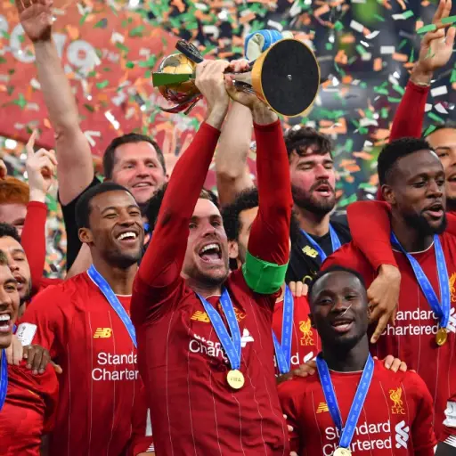 Liverpool's English midfielder Jordan Henderson (C) lifts the trophy after winning the 2019 FIFA Club World Cup Final football match between England's Liverpool and Brazil's Flamengo at the Khalifa International Stadium in the Qatari capital Doha on Decem