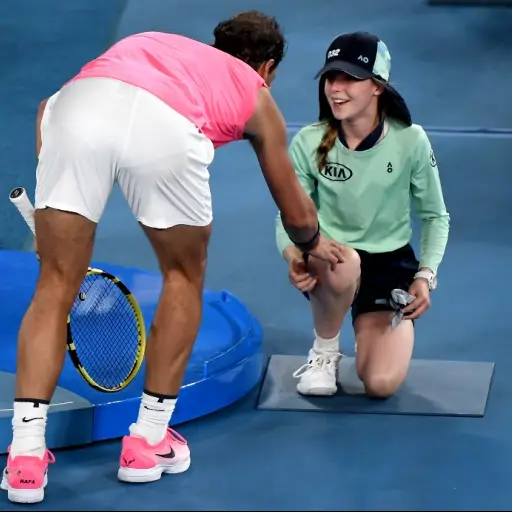 Spain's Rafael Nadal speaks with a ball kid who was hit by the ball during the men's singles match against Argentina's Federico Delbonis on day four of the Australian Open tennis tournament in Melbourne on January 23, 2020. (Photo by Manan VATSYAYANA / AF
