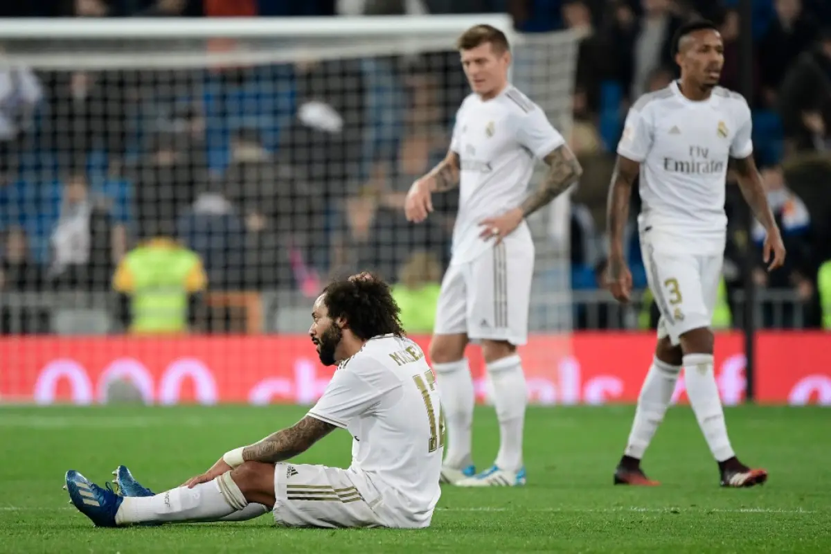 Real Madrid's Brazilian defender Marcelo reacts to his team's defeat sitting on the field during the Spanish Copa del Rey (King's Cup) quarter-final football match Real Madrid CF against Real Sociedad at the Santiago Bernabeu stadium in Madrid on February