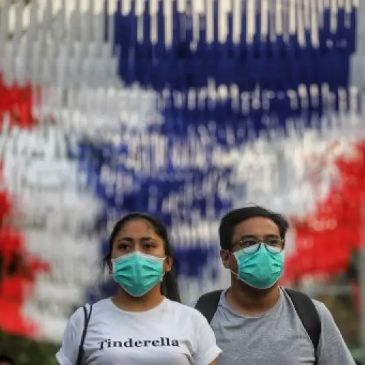 People wearing protective facemasks browse stalls at the Chatuchak weekend market in Bangkok on February 8, 2020, as tourist numbers drop across the region due to the novel coronavirus. - Nearly 35,000 people have been infected by the new virus strain, wh