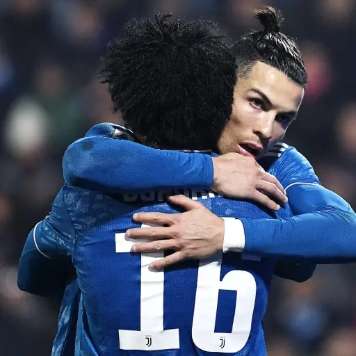 Juventus' Portuguese forward Cristiano Ronaldo (R) celebrates with Juventus' Colombian midfielder Juan Cuadrado after opening the scoring during the Italian Serie A football match SPAL vs Juventus on February 22, 2020 at the Paolo-Mazza stadium in Ferrara