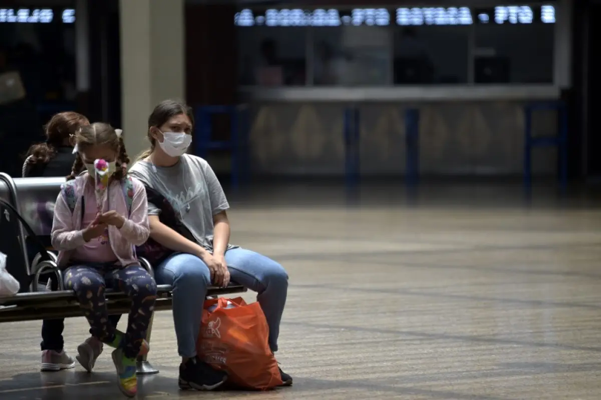 Passengers at Bogota's bus terminal use masks, as a preventive measure in the face of the global COVID-19 coronavirus pandemic, in Bogota on March 13, 2020. - Colombia declared on March 12, 2020 a "Health Emergency" due to the new coronavirus pandemic, a 