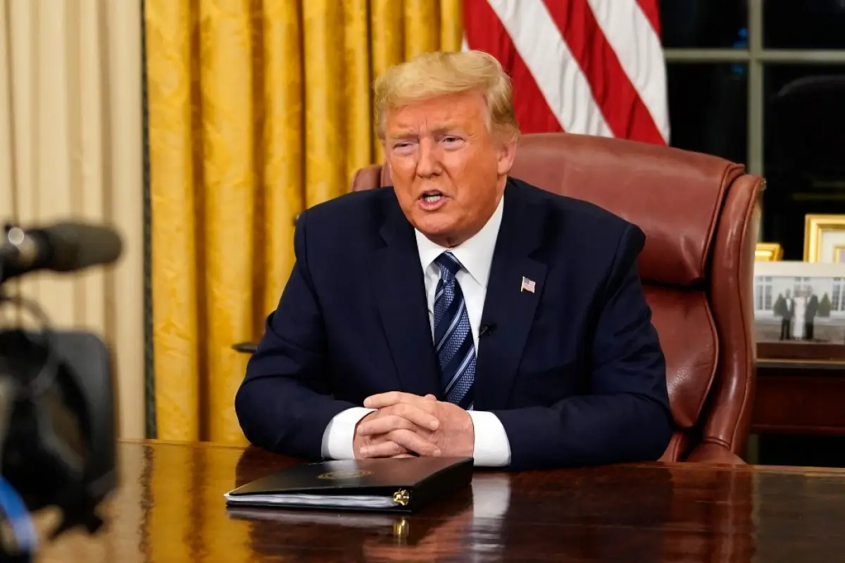 US President Donald Trump addresses the Nation from the Oval Office about the widening novel coronavirus (Covid-19) crisis in Washington, DC on March 11, 2020. - President Donald Trump announced on March 11, 2020 the United States would ban all travel fro