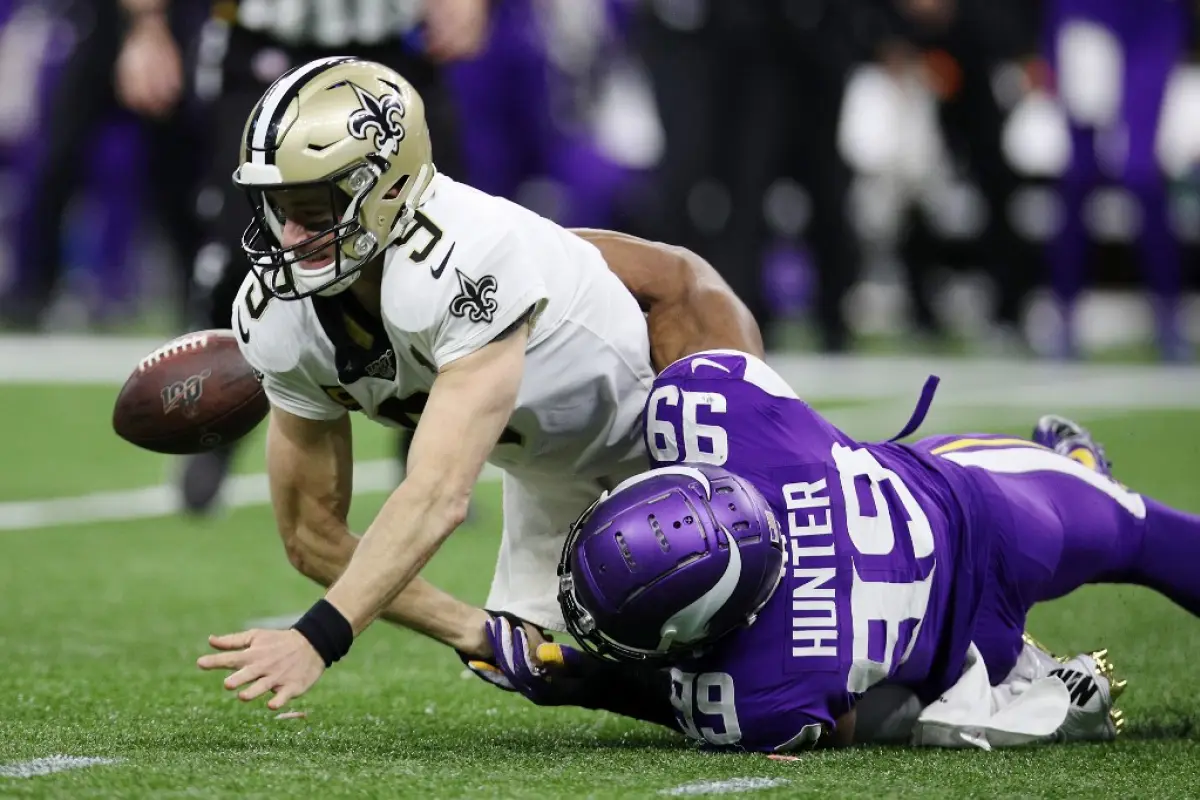 NEW ORLEANS, LOUISIANA - JANUARY 05: Drew Brees #9 of the New Orleans Saints fumbles the ball as he is sacked by Danielle Hunter #99 of the Minnesota Vikings during the fourth quarter in the NFC Wild Card Playoff game at Mercedes Benz Superdome on January