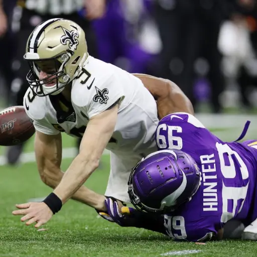NEW ORLEANS, LOUISIANA - JANUARY 05: Drew Brees #9 of the New Orleans Saints fumbles the ball as he is sacked by Danielle Hunter #99 of the Minnesota Vikings during the fourth quarter in the NFC Wild Card Playoff game at Mercedes Benz Superdome on January