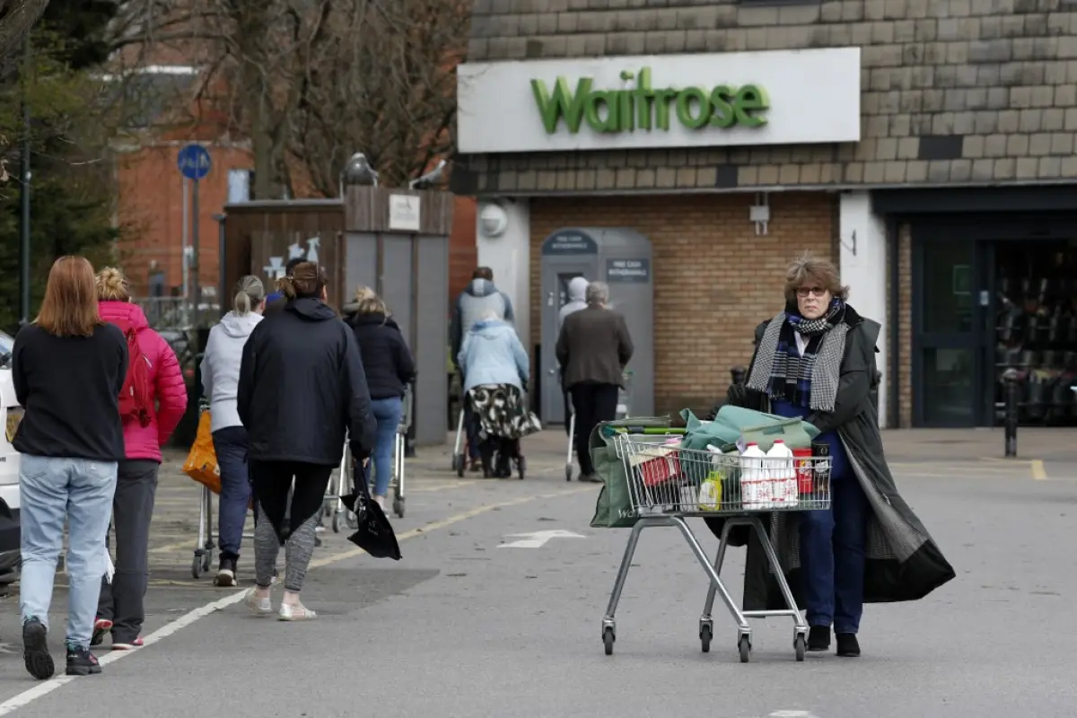 Shoppers visit a Waitrose supermarket in Frimley, south west of London on March 29, 2020, as life in Britain continues during the nationwide lockdown to combat the novel coronavirus pandemic. - Prime Minister Boris Johnson warned Saturday the coronavirus 