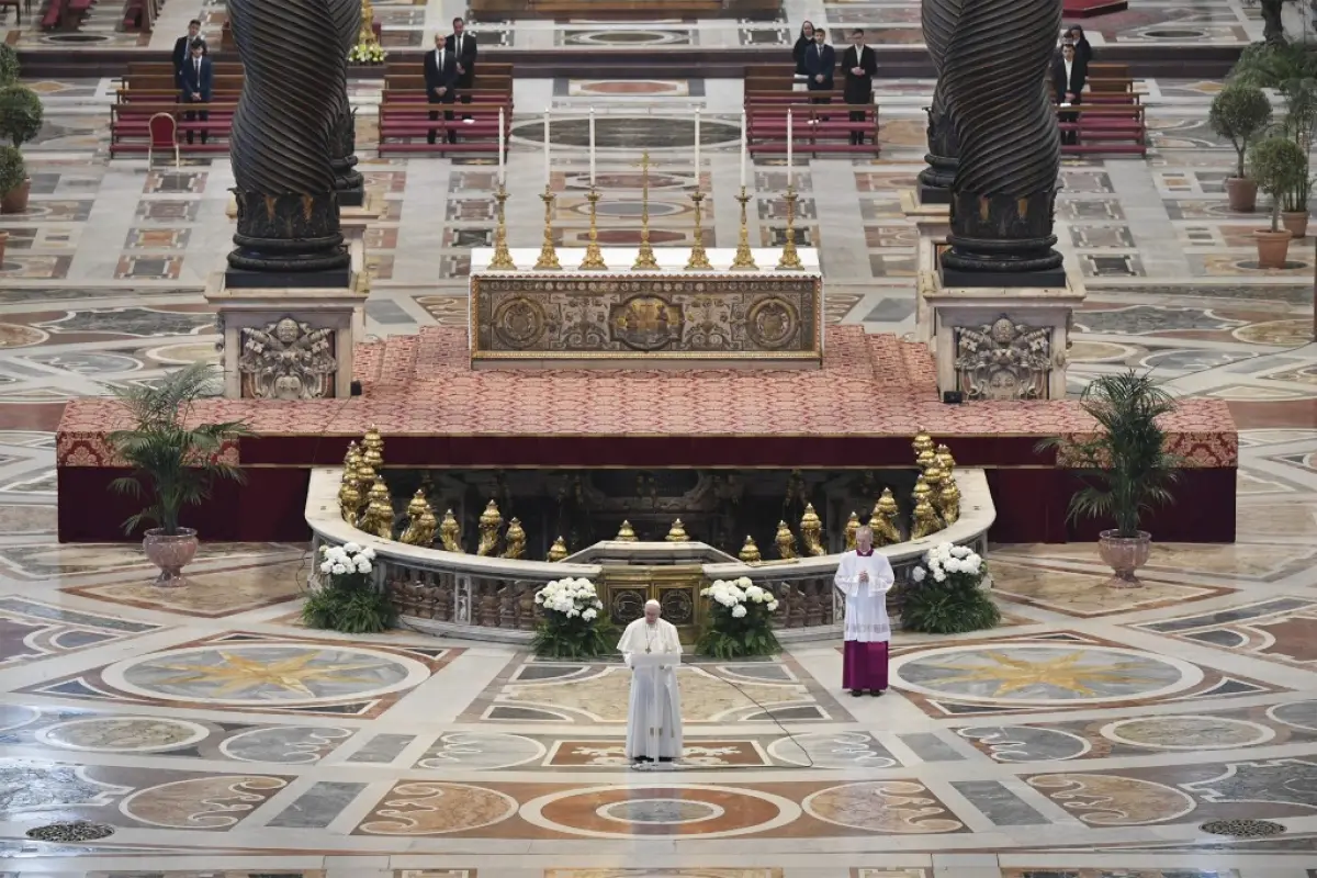 This photo taken and handout on April 12, 2020 by the Vatican Media shows Pope Francis (Bottom C) deliver his Urbi et Orbi message following Easter Sunday Mass on April 12, 2020 behind closed doors at St. Peter's Basilica in The Vatican, during the countr