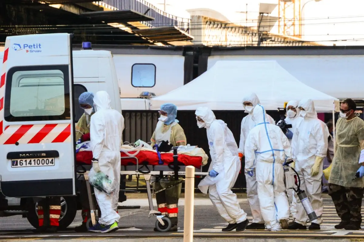 Medical workers load a patient infected with the COVID-19 in an ambulance after his or her arrival in a medicalised TGV high speed train on April 10, 2020 at Bordeaux's train station with 24 coronavirus patients on board to be dispatched in several hospit