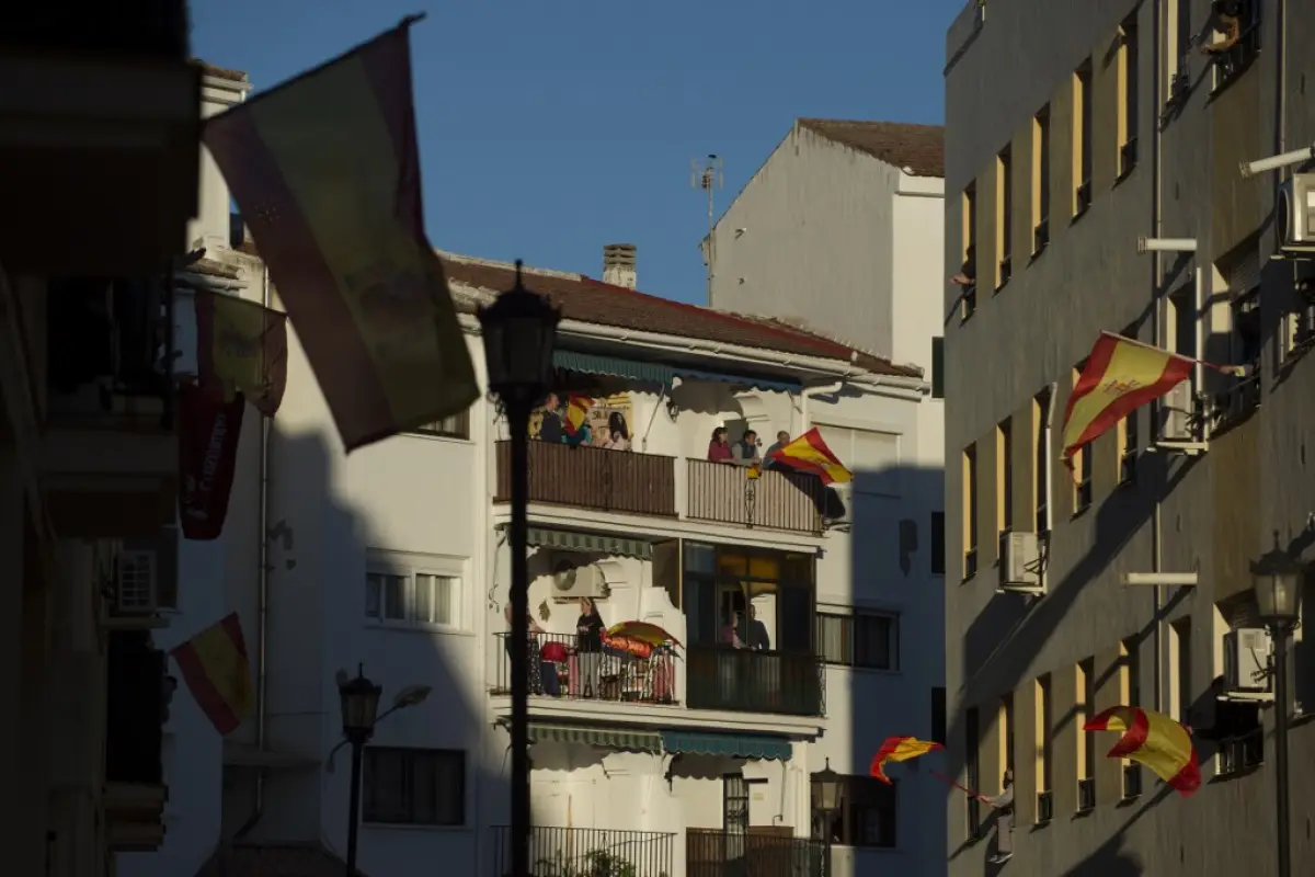 People applaud on their balconies to thank healthcare workers dealing with the COVID-19 coronavirus in Ronda on April 3, 2020 during a national lockdown to prevent the spread of the COVID-19 coronavirus. - More than 900 people died in Spain over the past 