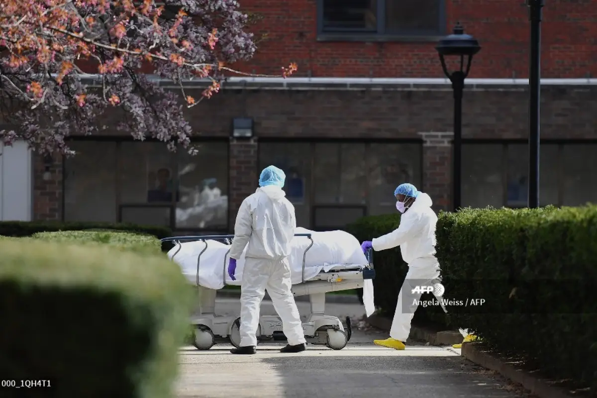 Medical personnel wearing personal protective equipment transport the body of a deceased patient from a refrigerated truck to Kingsbrook Jewish Medical Center on April 8, 2020 in Brooklyn, New York. - New York state has recorded its highest number of COVI