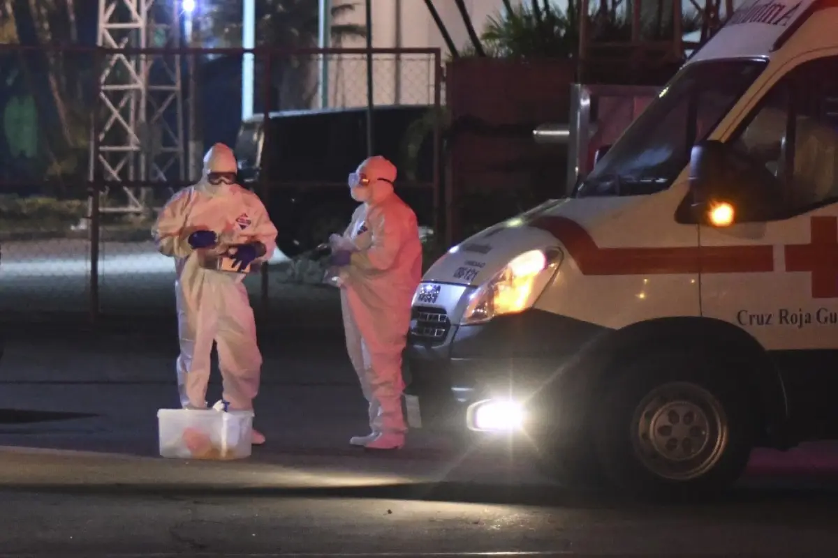 Members of the Guatemalan Red Cross wear protective suits after transporting fifteen patients infected with the new coronavirus (COVID-19) from the hospital of Villa Nueva to the new temporary hospital at Industry Park in five ambulances in Guatemala City