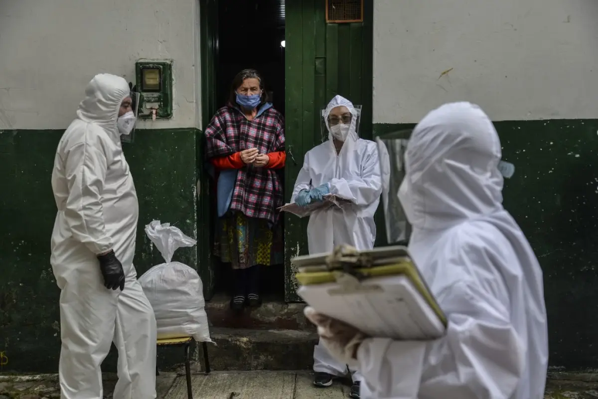 Workers of Bogota's Mayor's office wear protective suits to avoid getting infected with COVID-19 as they conduct a census at Egipto (Egypt) neighbourhood in Bogota on April 19, 2020 to know how many families need to be provided with food to prevent them f