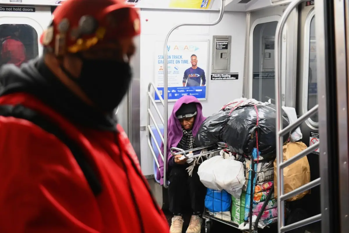 Jose Niejiaz of Guardian Angels delivers food and essentials to people in need in the subway on April 29, 2020 in New York City. - New York Citys homeless have sought refuge in the subways to escape the coronavirus pandemic, causing subway workers to ask