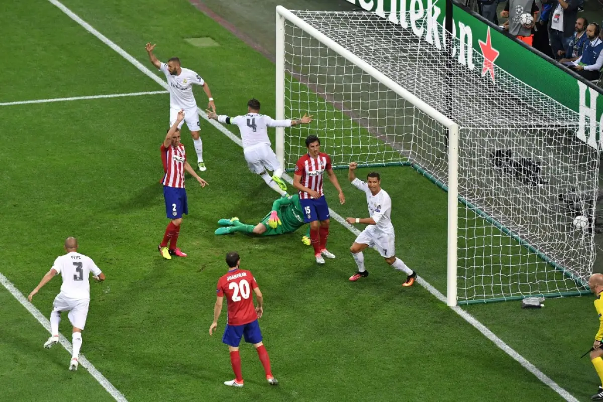 Real Madrid's Spanish defender Sergio Ramos (4) reacts after scoring the first goal of the match during the UEFA Champions League final football match between Real Madrid and Atletico Madrid at San Siro Stadium in Milan, on May 28, 2016. (Photo by TIZIANA