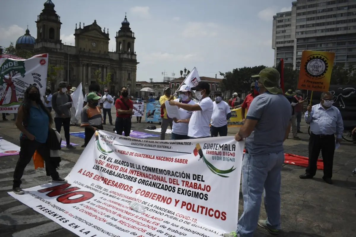 Workers wear face masks during a May Day protest amid the COVID-19 outbreak caused by the novel coronavirus in Guatemala City on May 1, 2020. - With strict social distancing rules in most countries to halt the spread of the novel coronavirus, many union l