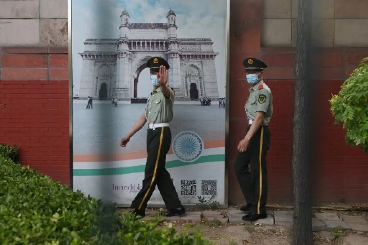 Two Chinese paramilitary police officers patrol outside the Indian embassy in Beijing on June 16, 2020. - China on June 16 accused India of crossing a disputed border between the two countries, as the Indian army said three of its soldiers had been killed