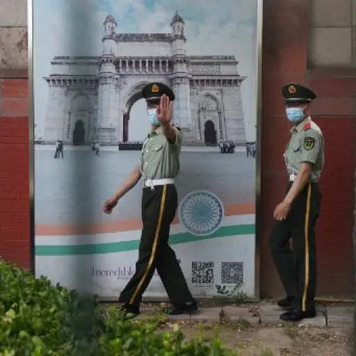Two Chinese paramilitary police officers patrol outside the Indian embassy in Beijing on June 16, 2020. - China on June 16 accused India of crossing a disputed border between the two countries, as the Indian army said three of its soldiers had been killed