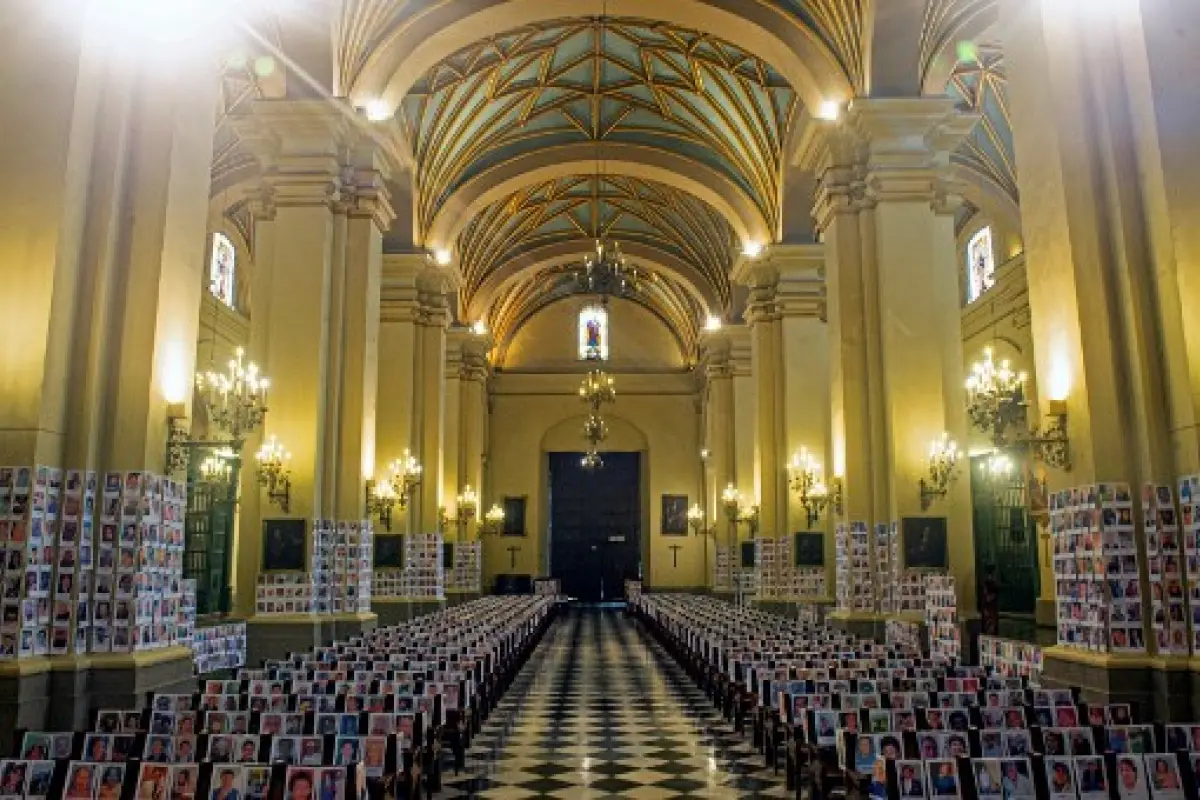 The portraits of over 5,000 Peruvian victims of COVID-19 are displayed in the Cathedral of Lima on June 14, 2020. (Photo by ERNESTO BENAVIDES / AFP)