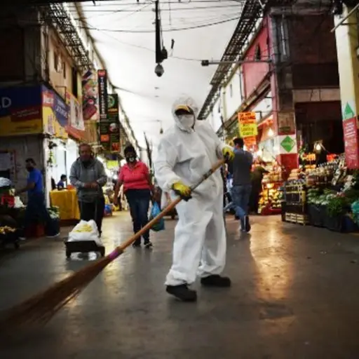 A workers wearing protective gear sweeps the floor sweeps the floor at the Central de Abastos market in Mexico City, on June 10, 2020 during the COVID-19 coronavirus pandemic. - The Central de Abastos (CEDA), the vast wholesale market in Mexico City that 