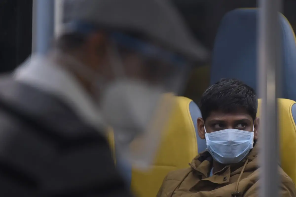 An indian citizen sits on a bus that will take him to a quarantine hotel after landing from London into Chhatrapati Shivaji International Airport as part of a massive repatriation effort due to the COVID-19 coronavirus pandemic, in Mumbai on May 10, 2020.